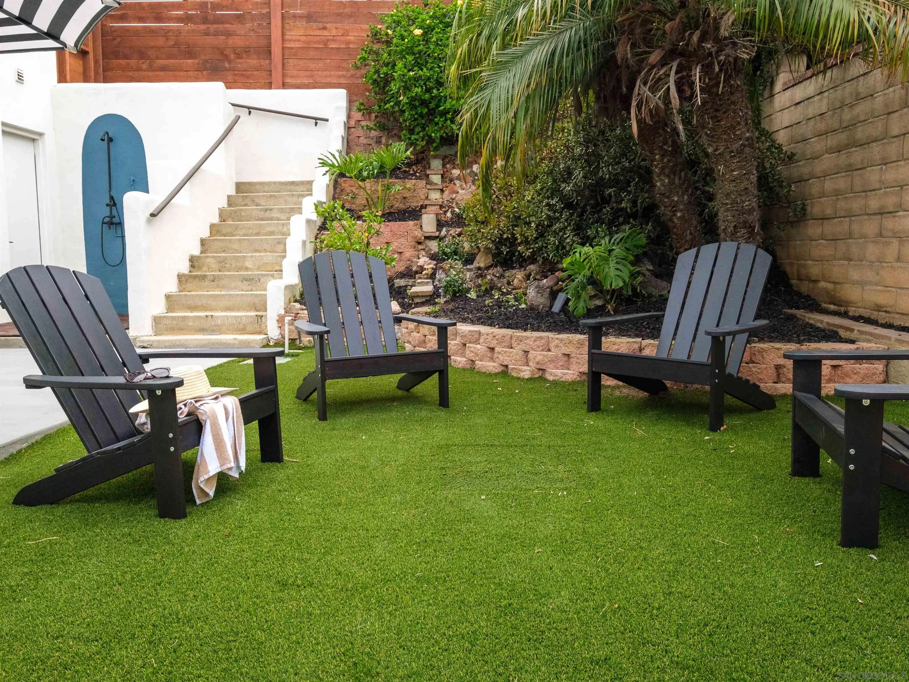 1915 Montgomery Avenue Cardiff-by-the-Sea, CA 92007 - Photo 22 of 32 a view of a chair and table in the back yard