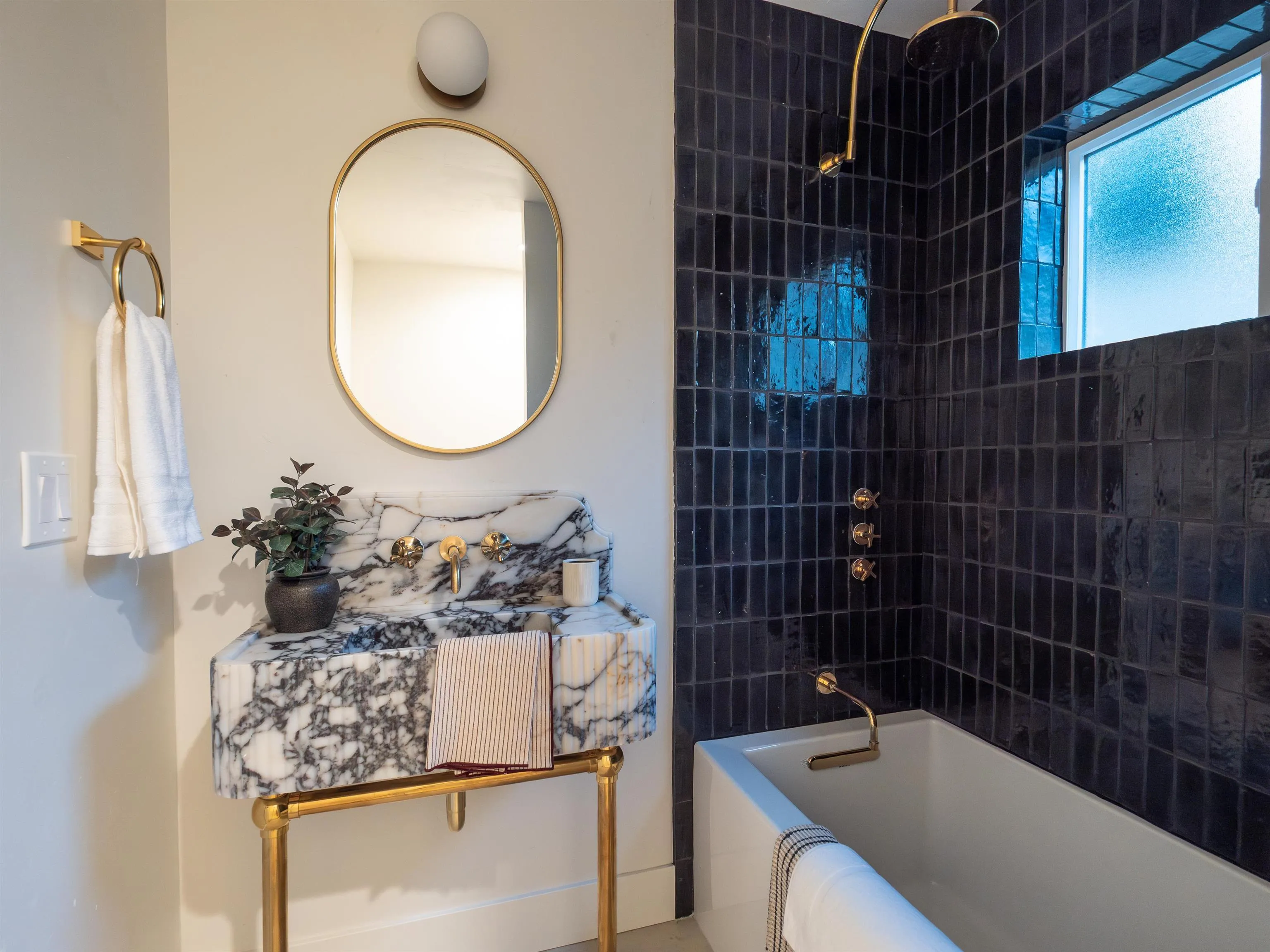 1915 Montgomery Avenue Cardiff-by-the-Sea, CA 92007 - Photo 28 of 32 a bathroom with a granite countertop sink a mirror and bathtub