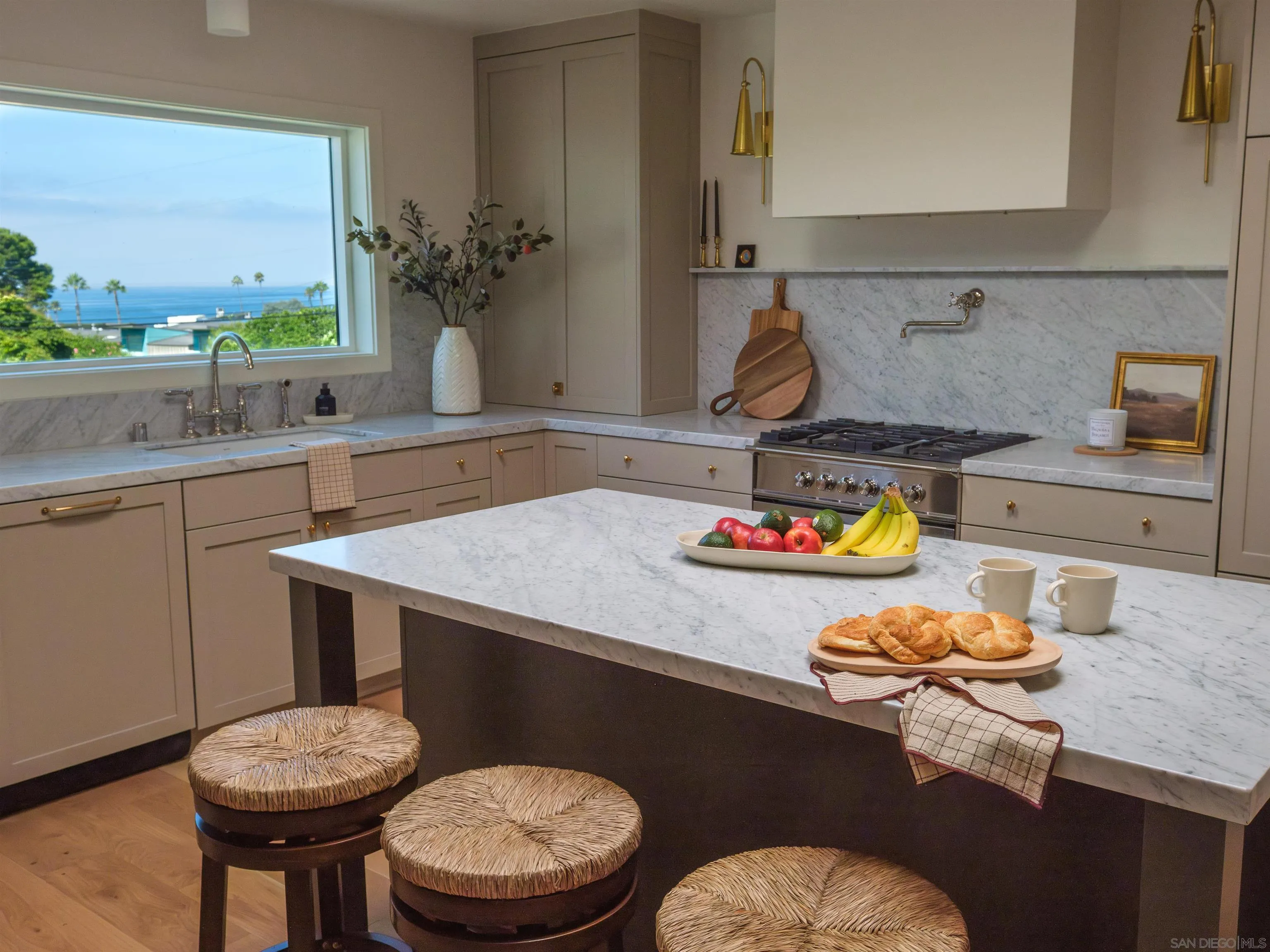 1915 Montgomery Avenue Cardiff-by-the-Sea, CA 92007 - Photo 5 of 32 a kitchen with a sink a stove and a wooden cabinets