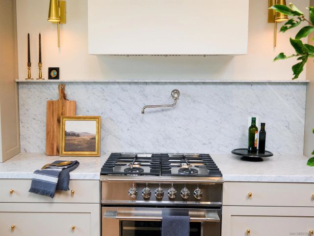 a stove top oven sitting inside of a kitchen