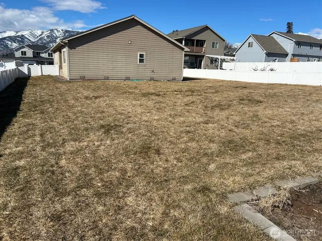 an empty room with wooden floor and bathroom