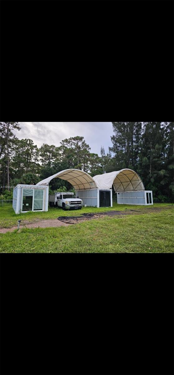 15696 Ferris Place Loxahatchee, FL 33470 - Photo 5 of 9 a view of a big yard with a large tree