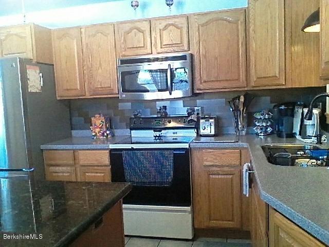 74 East Main Road Peru, MA 01235 - Photo 5 of 22 a kitchen with stainless steel appliances granite countertop a refrigerator a stove and a sink