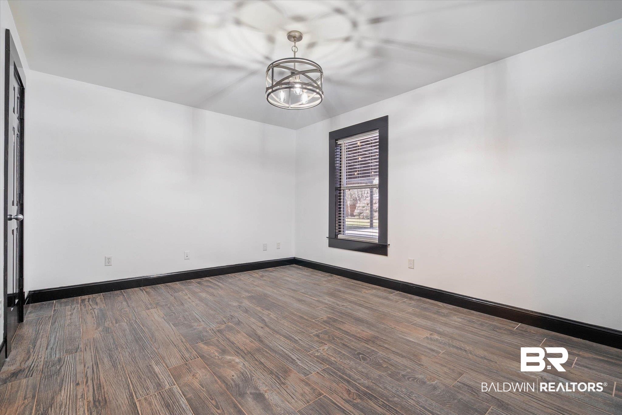 3216 Bay Booster Club Road Theodore, AL 36582 - Photo 16 of 46 Empty room featuring dark wood-style floors and a chandelier
