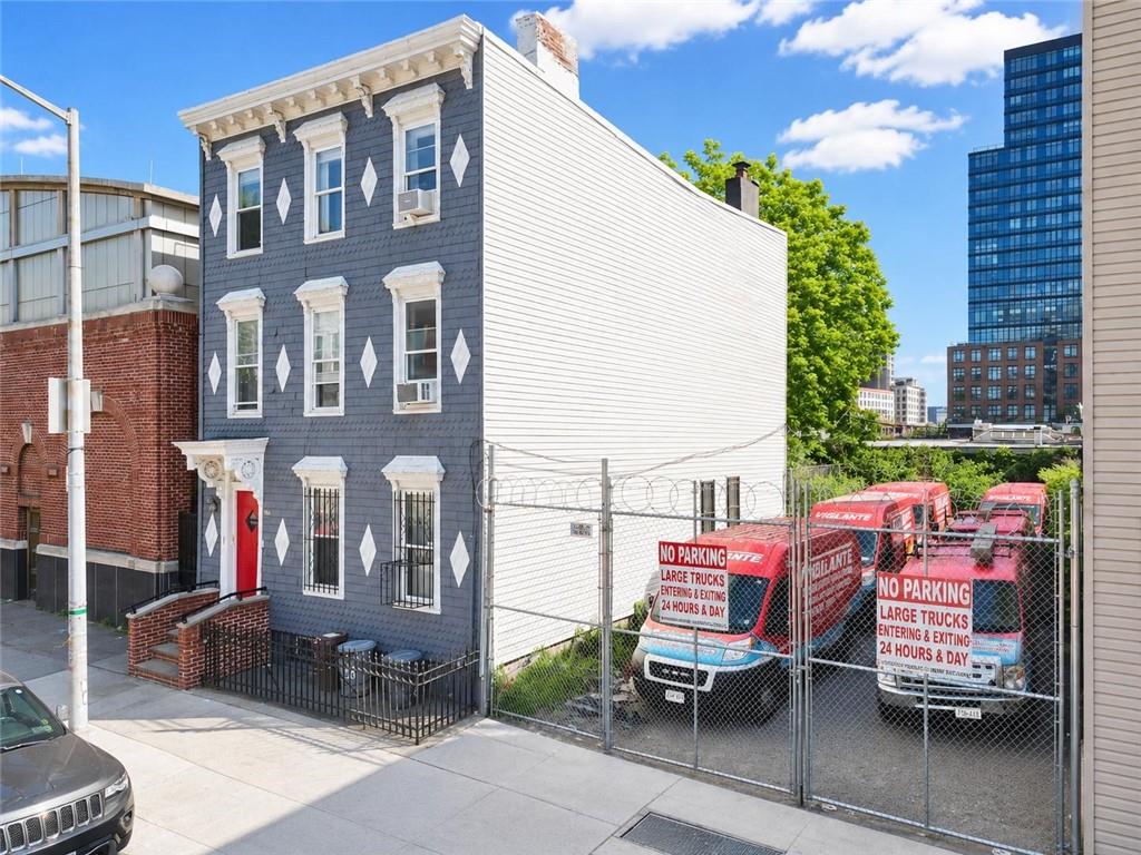 192 Butler Street Brooklyn, NY 11217 - Photo 5 of 16 a view of a brick building with a bench in front of building
