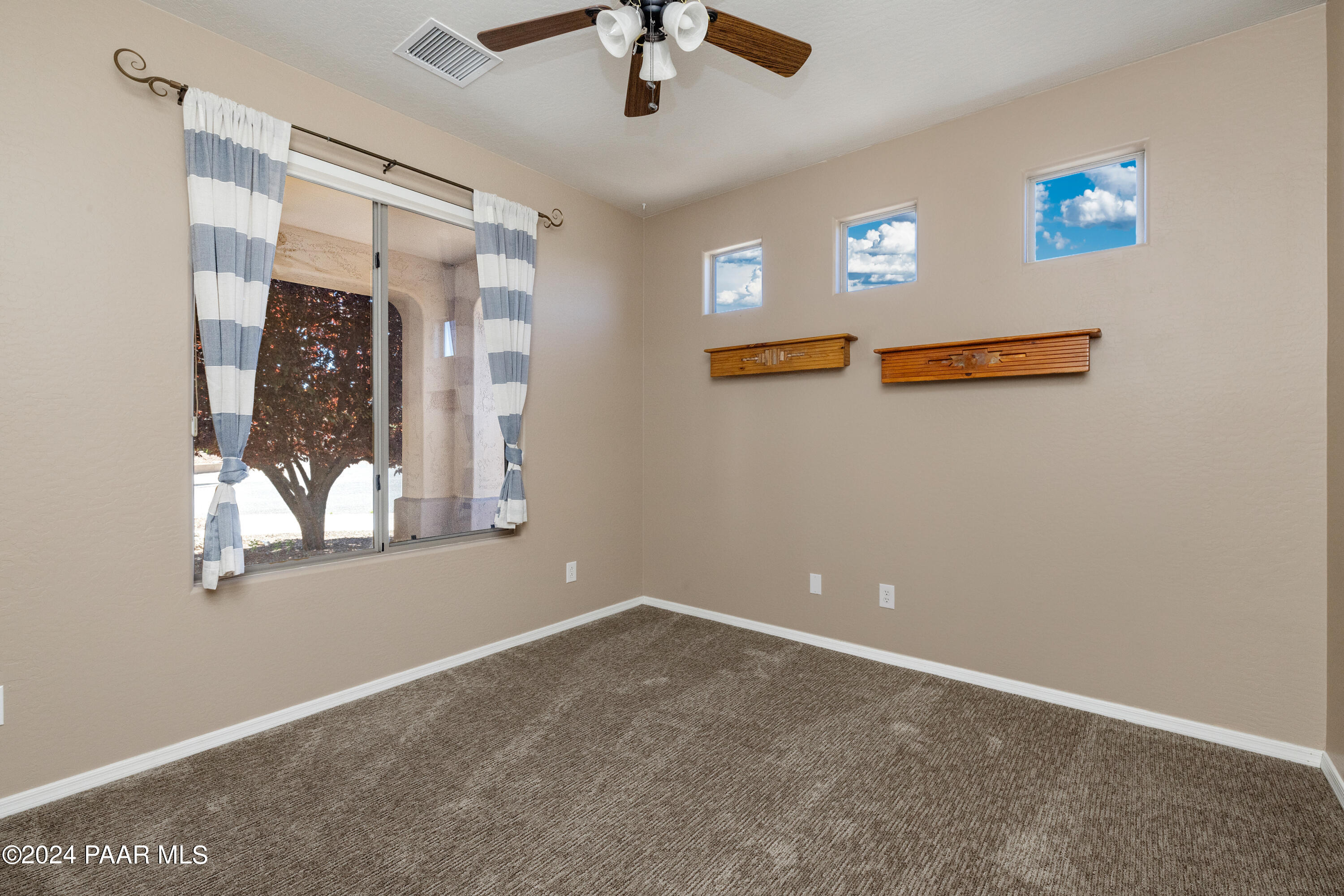 1195 Rigo Ranch Road Prescott Valley, AZ 86314 - Photo 9 of 65 an empty room with windows and fan