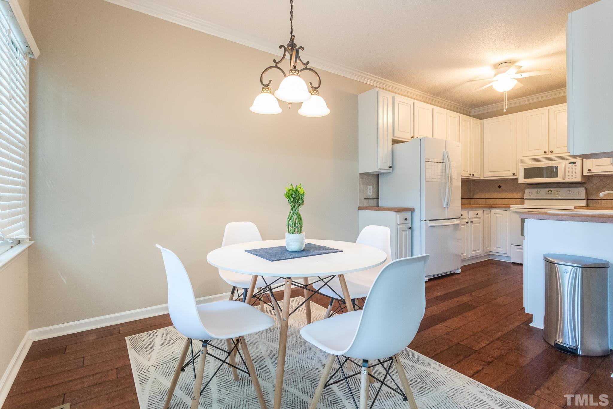 3722 Carnegie Lane Raleigh, NC 27612 - Photo 11 of 30 a view of a dining room with furniture and wooden floor