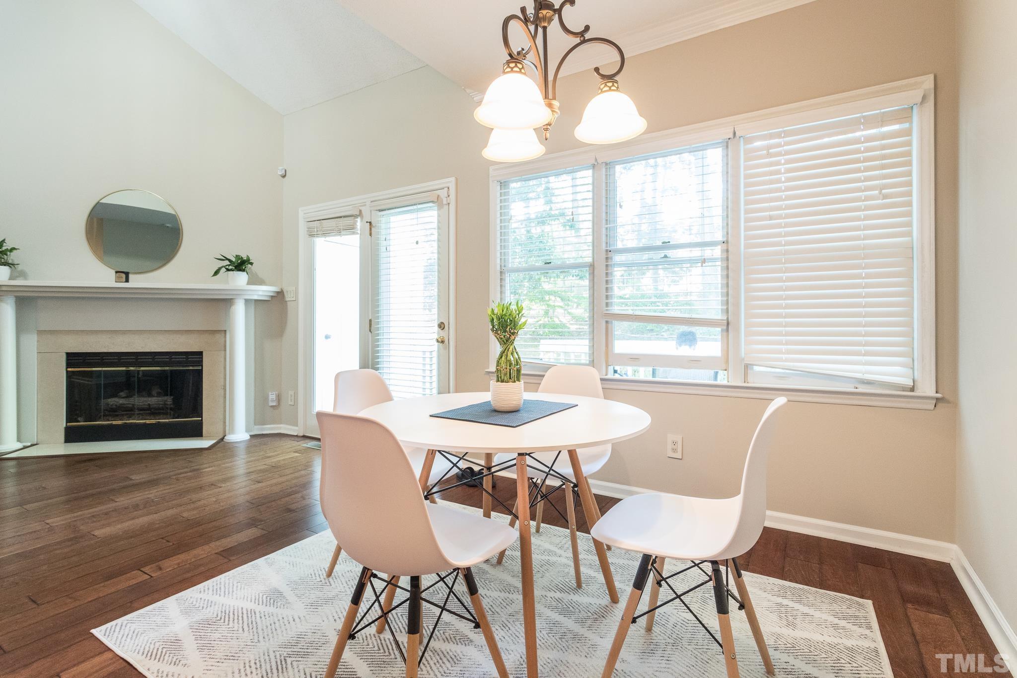 3722 Carnegie Lane Raleigh, NC 27612 - Photo 13 of 30 a view of a dining room with furniture window and wooden floor