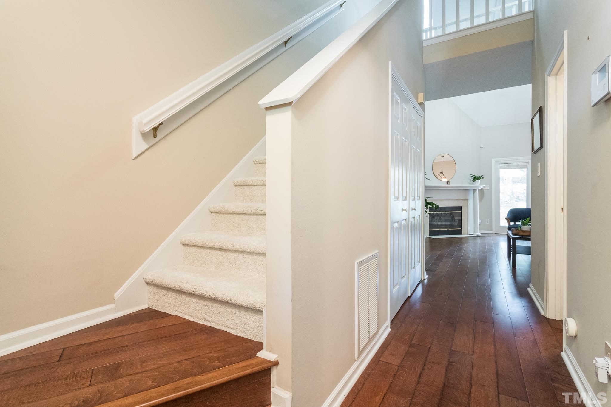 3722 Carnegie Lane Raleigh, NC 27612 - Photo 6 of 30 a view of a hallway with wooden floor and staircase