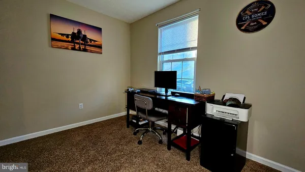 a view of a workspace with furniture