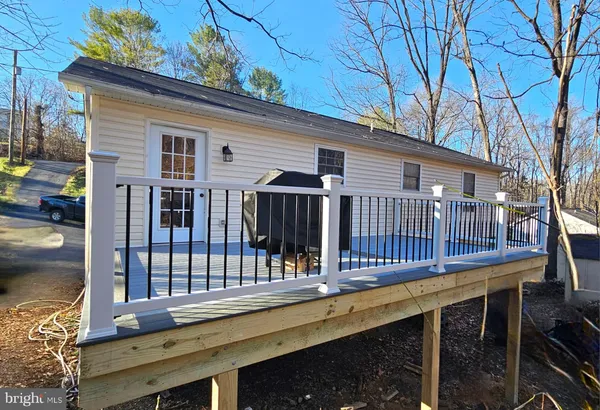a view of a house with a wooden deck