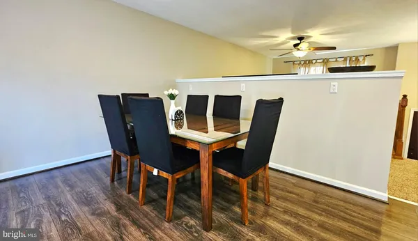 a dining room with furniture and wooden floor