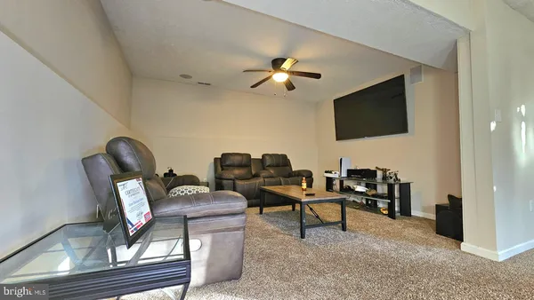 a work room with furniture and a flat screen tv