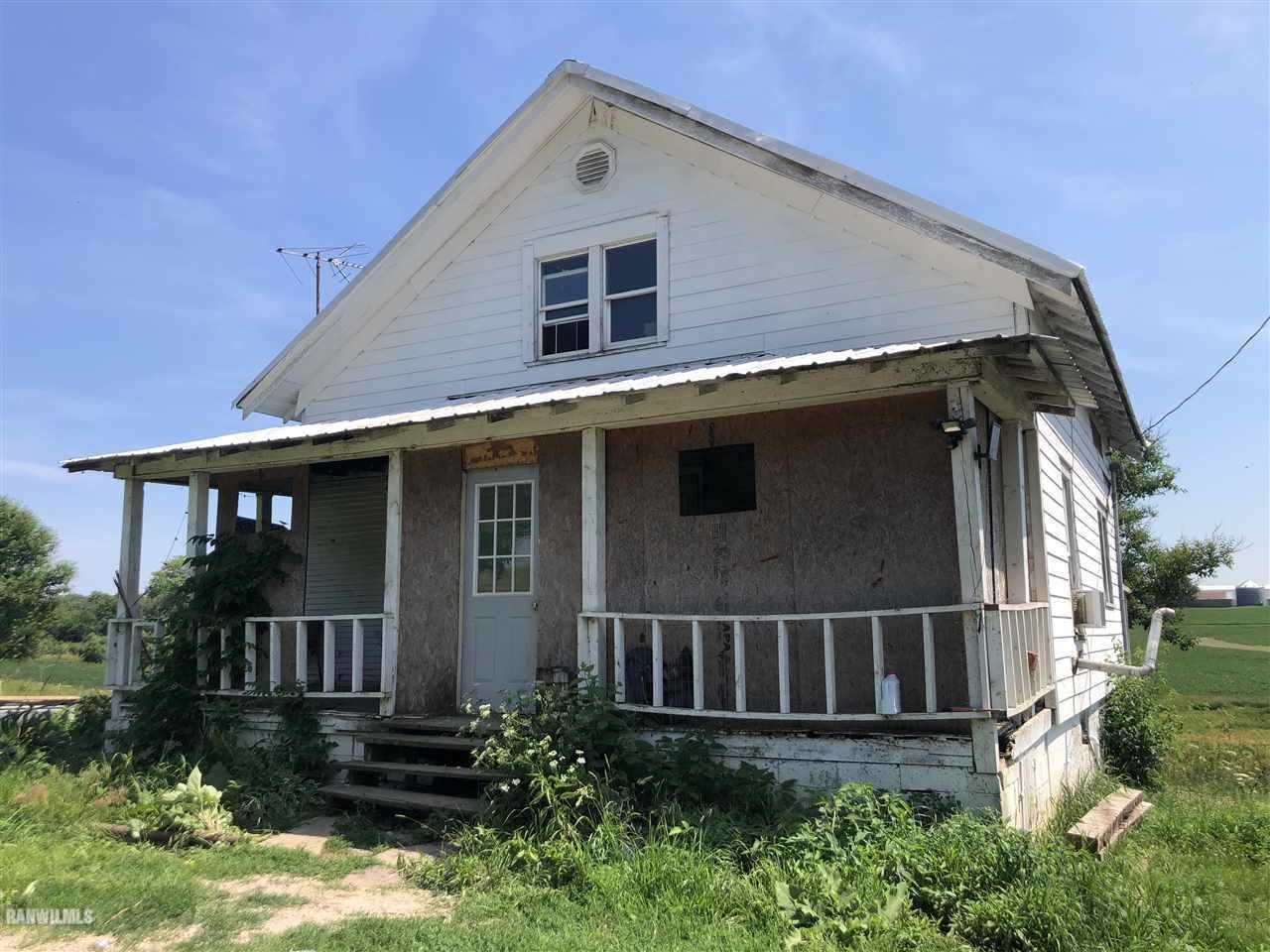 a front view of a house with plants
