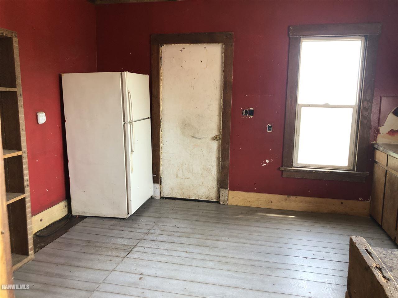 5998 Daggert Road Mount Carroll, IL 61053 - Photo 3 of 12 an empty room with wooden floor and windows