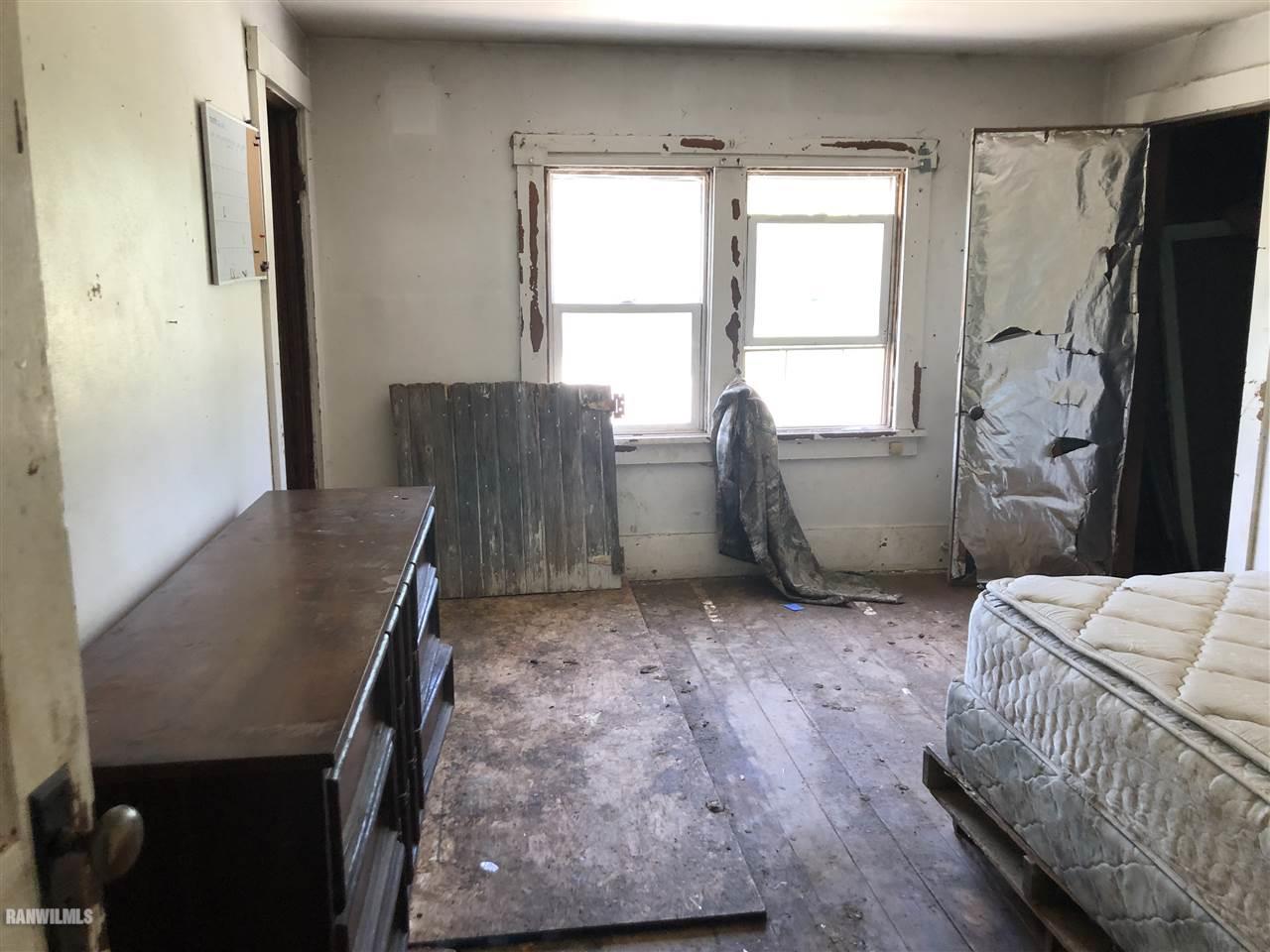 5998 Daggert Road Mount Carroll, IL 61053 - Photo 10 of 12 a bedroom with a bed and a window