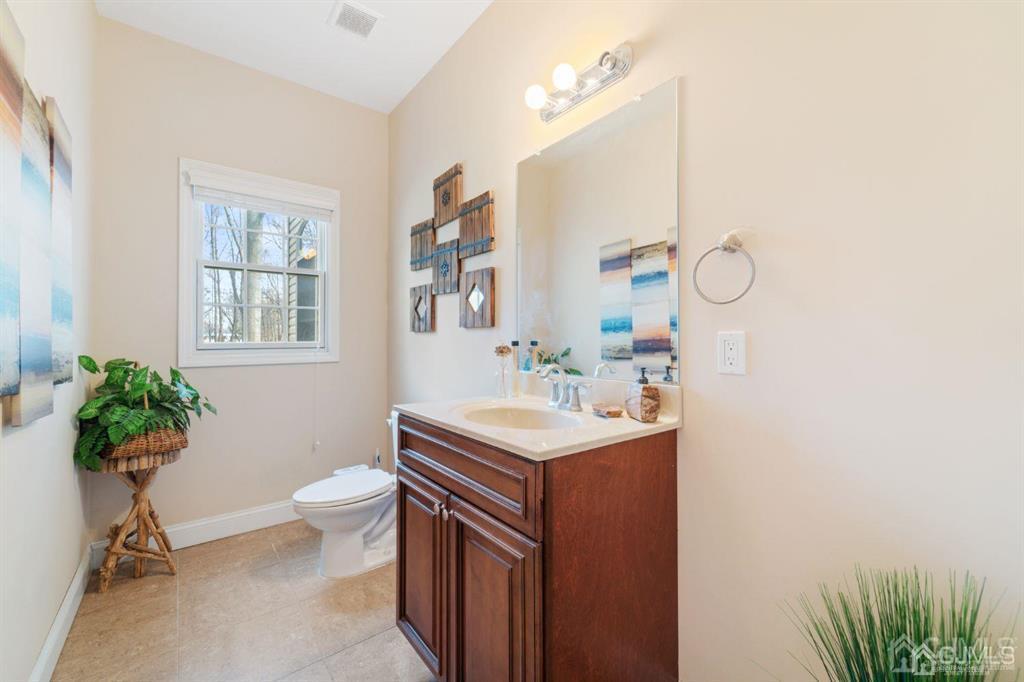 22 Utica Road Edison, NJ 08820 - Photo 14 of 28 a bathroom with a sink toilet and a mirror