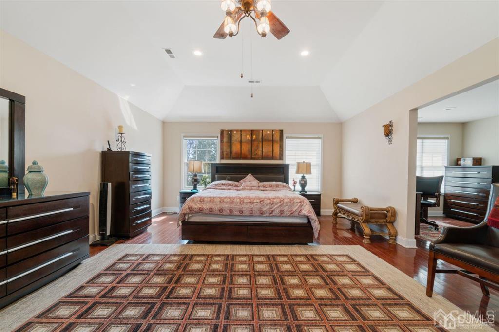 22 Utica Road Edison, NJ 08820 - Photo 18 of 28 a bedroom with a large bed and a chandelier