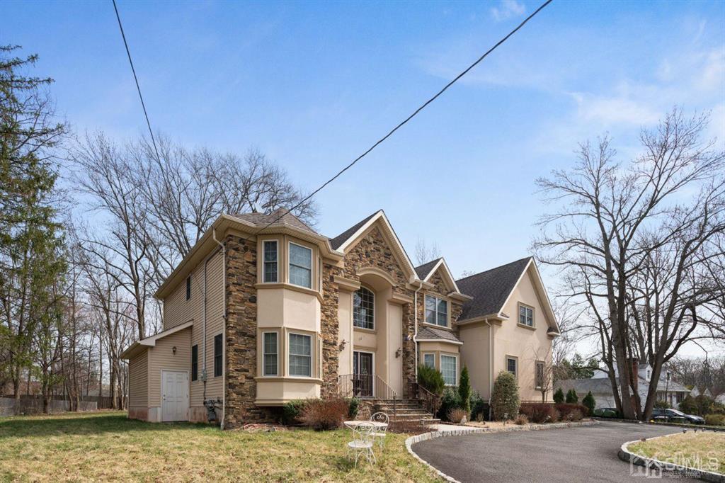 22 Utica Road Edison, NJ 08820 - Photo 2 of 28 a front view of a house with a yard
