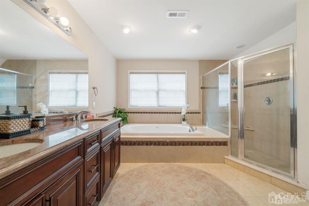 22 Utica Road Edison, NJ 08820 - Photo 22 of 28 a spacious bathroom with a tub sink and mirror