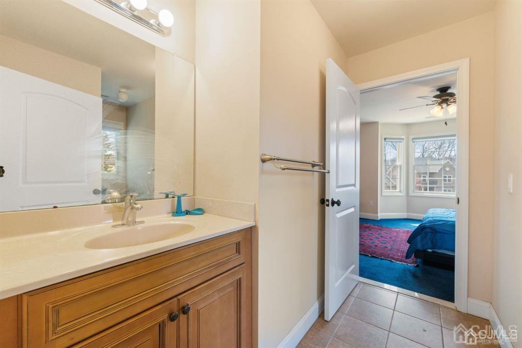 22 Utica Road Edison, NJ 08820 - Photo 25 of 28 a bathroom with a sink and a mirror