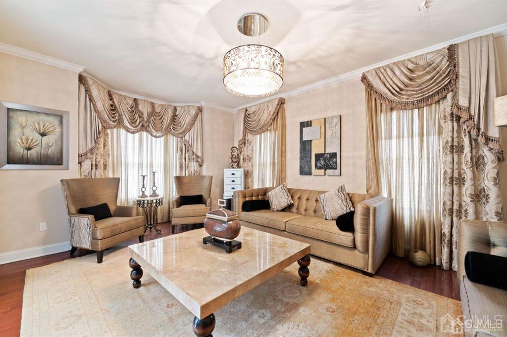 22 Utica Road Edison, NJ 08820 - Photo 6 of 28 a living room with furniture a fireplace and a chandelier