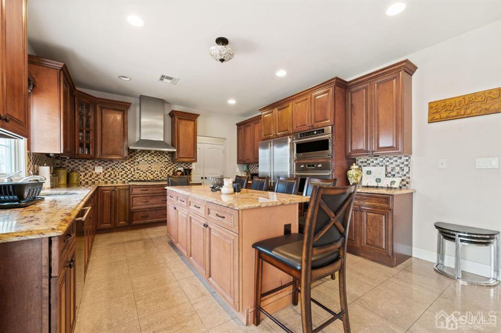 22 Utica Road Edison, NJ 08820 - Photo 10 of 28 a kitchen with a stove a sink a microwave a dining table and chairs