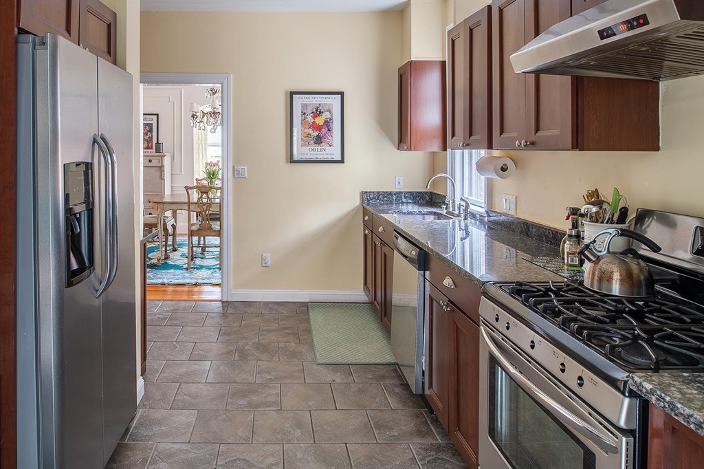 82 Atherton Road, Unit 1 Brookline, MA 02446 - Photo 4 of 9 a kitchen with stainless steel appliances granite countertop a stove a refrigerator and a sink