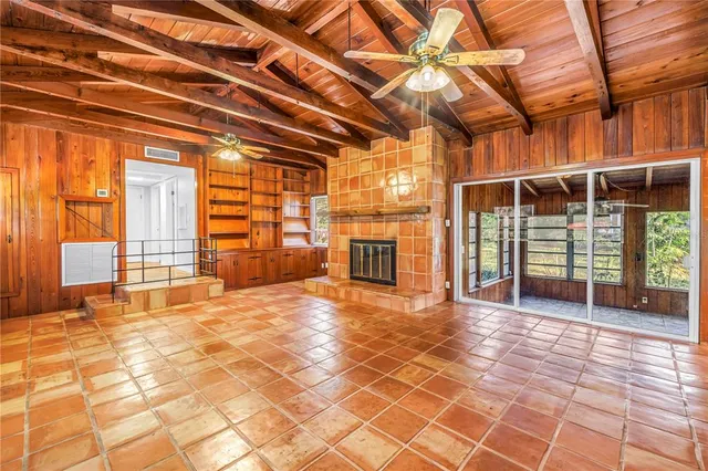 a view of a room with wooden floor and windows