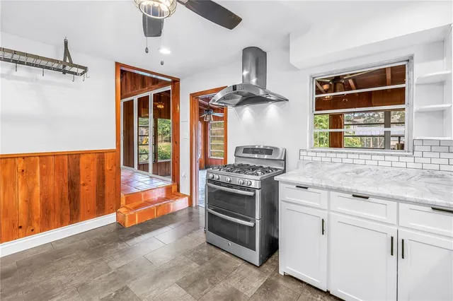 a kitchen with stainless steel appliances granite countertop a stove and a sink