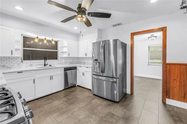 a kitchen with sink cabinets and stainless steel appliances