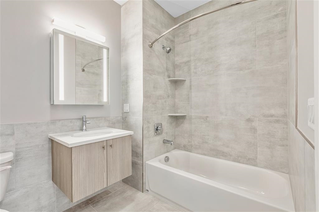 662 Avenue C, Unit 304 Bayonne, NJ 07002 - Photo 13 of 20 a bathroom with a sink and a bathtub