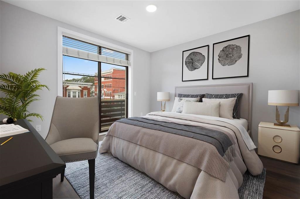 662 Avenue C, Unit 304 Bayonne, NJ 07002 - Photo 14 of 20 a bedroom with a large bed and a painting on the wall