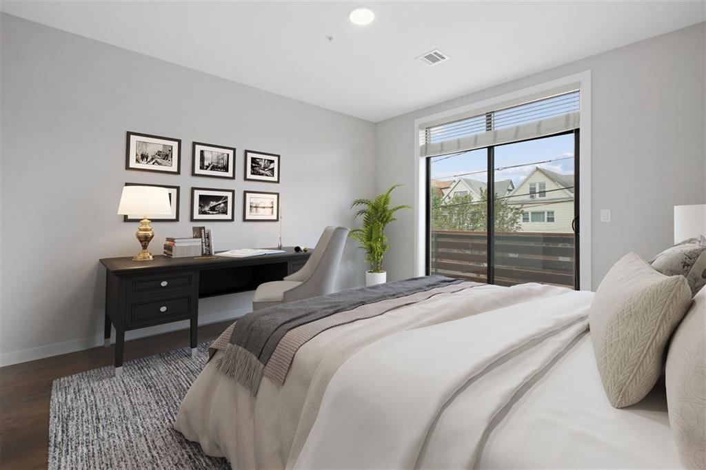 662 Avenue C, Unit 304 Bayonne, NJ 07002 - Photo 15 of 20 a bedroom with a bed and a painting on the wall