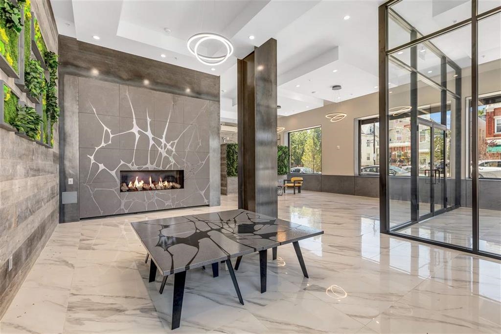 662 Avenue C, Unit 304 Bayonne, NJ 07002 - Photo 3 of 20 a view of a hall with furniture and floor to ceiling window