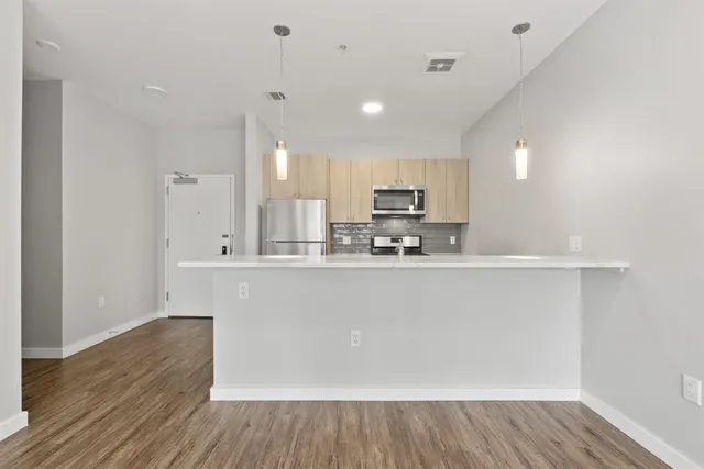 a view of empty room with wooden floor and wooden floor