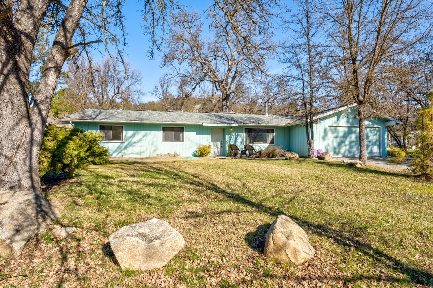 a view of a white house with a swimming pool