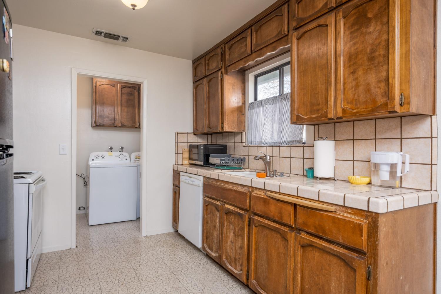 46011 Ming Circle Oakhurst, CA 93644 - Photo 12 of 37 a kitchen with a sink cabinets and window