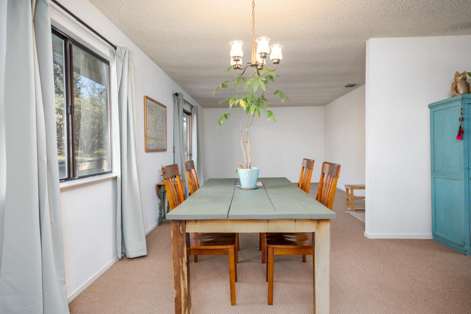 46011 Ming Circle Oakhurst, CA 93644 - Photo 15 of 37 a view of a dining room with furniture and chandelier