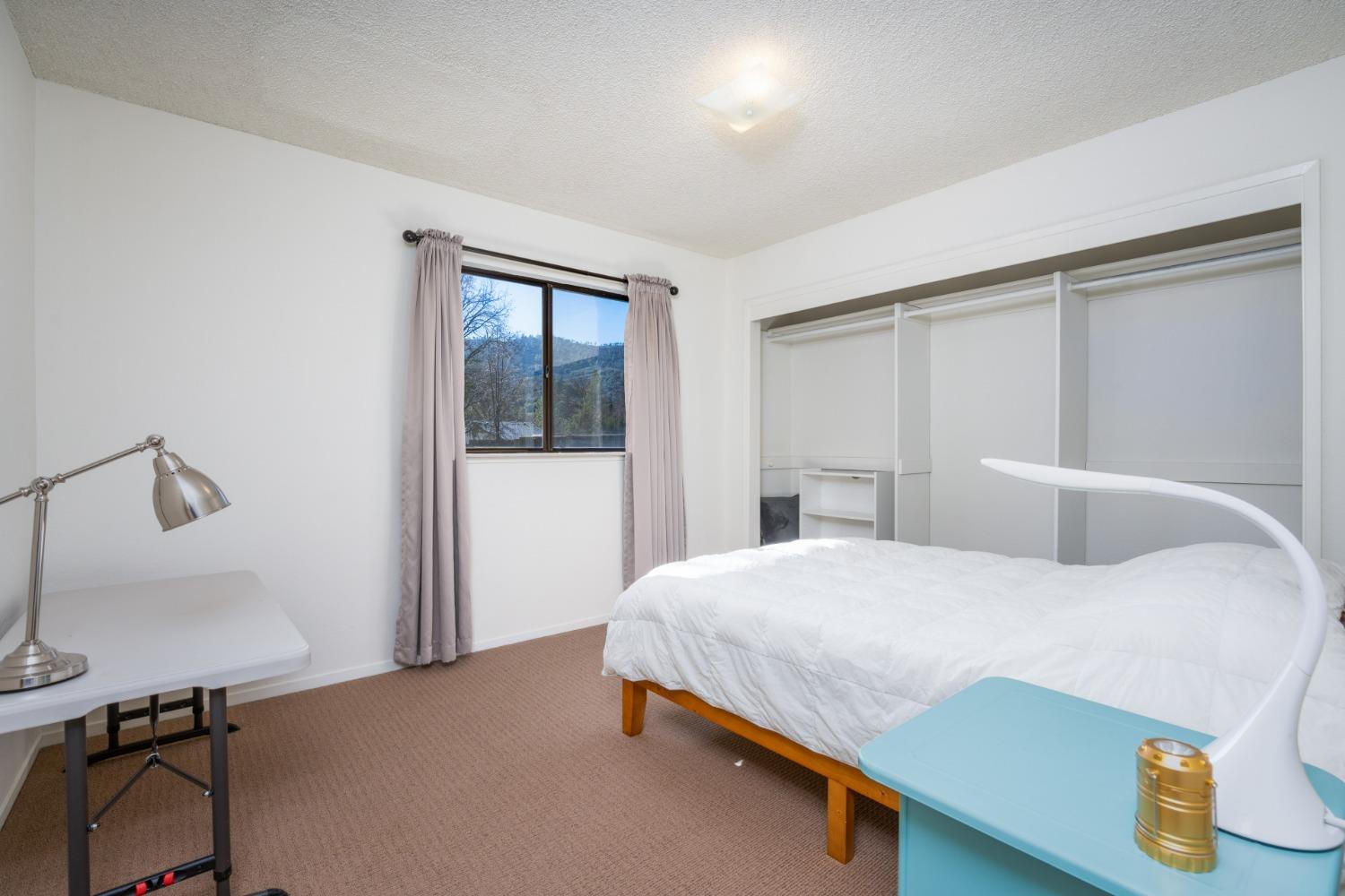 46011 Ming Circle Oakhurst, CA 93644 - Photo 22 of 37 a bedroom with a bed and a window