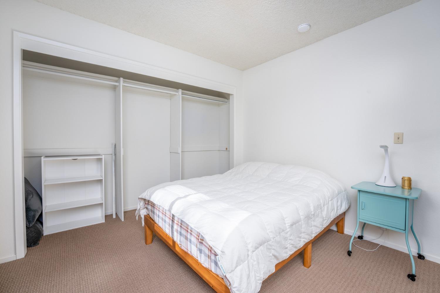 46011 Ming Circle Oakhurst, CA 93644 - Photo 23 of 37 a bedroom with a bed and a chair