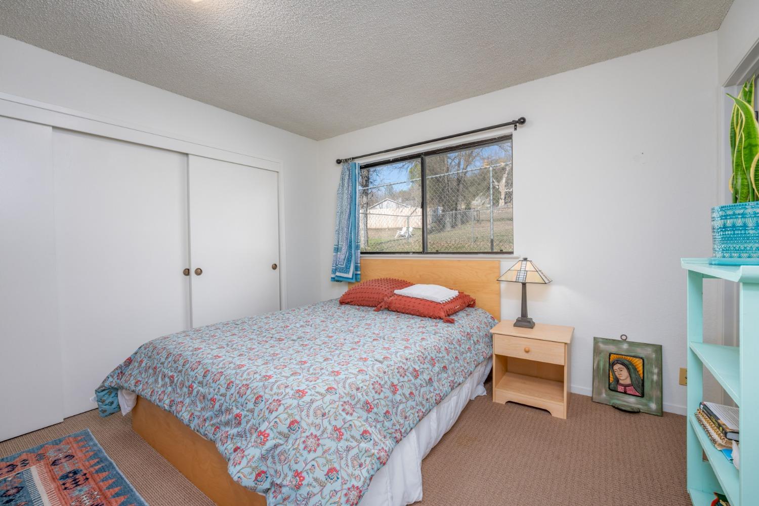 46011 Ming Circle Oakhurst, CA 93644 - Photo 24 of 37 a bedroom with a bed and a window