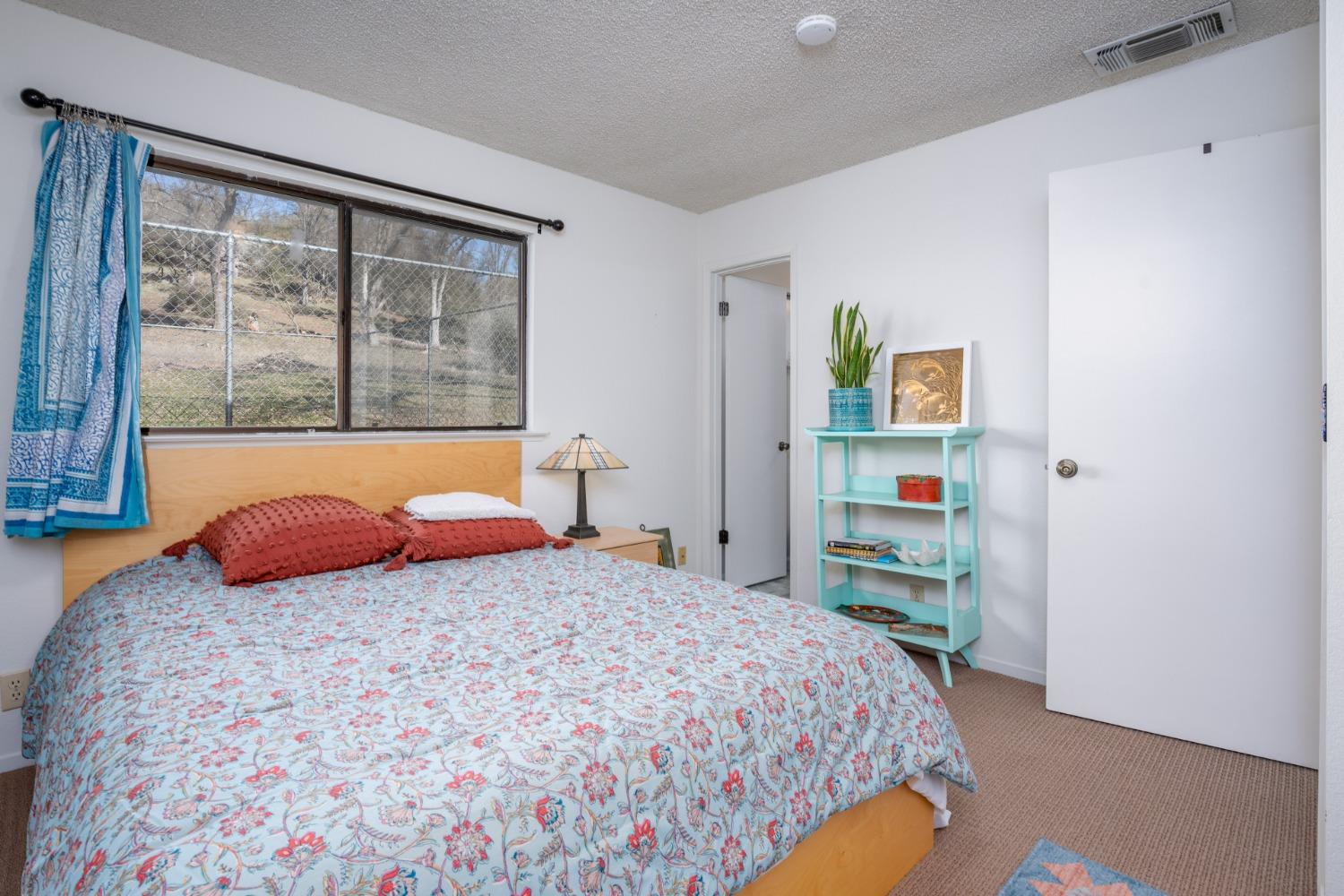 46011 Ming Circle Oakhurst, CA 93644 - Photo 26 of 37 a bedroom with a bed and a window