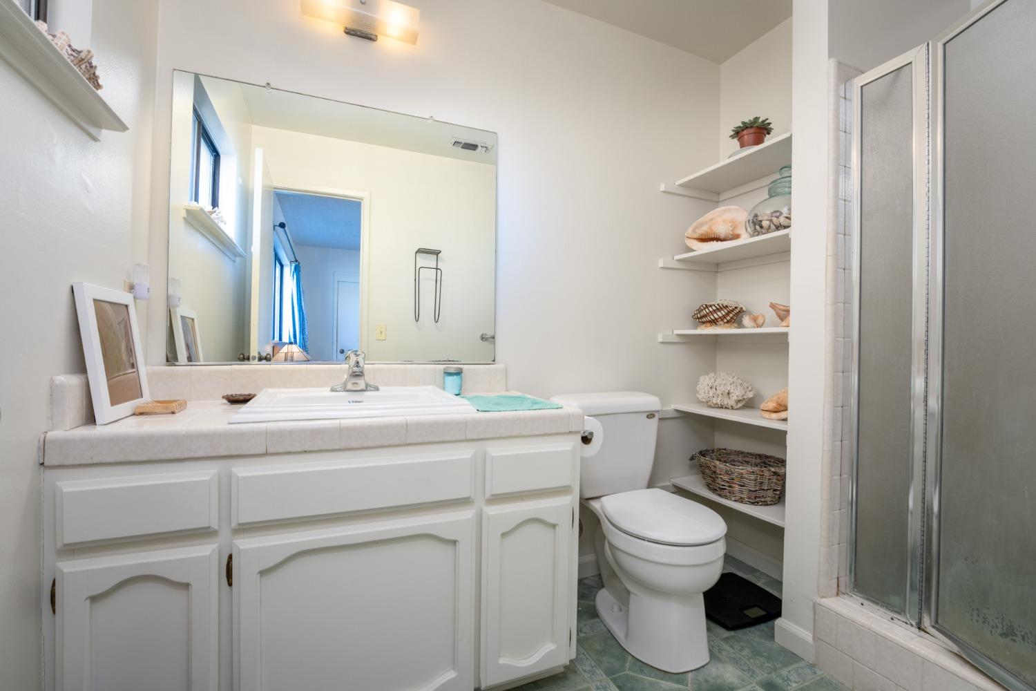 46011 Ming Circle Oakhurst, CA 93644 - Photo 27 of 37 a bathroom with a toilet sink and a mirror