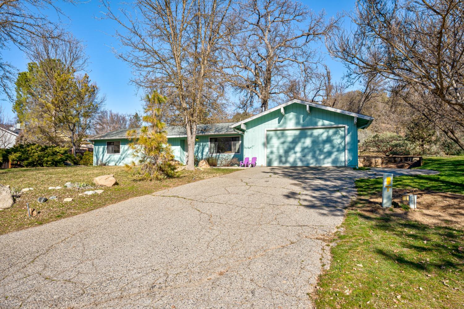46011 Ming Circle Oakhurst, CA 93644 - Photo 3 of 37 a front view of a house with a yard