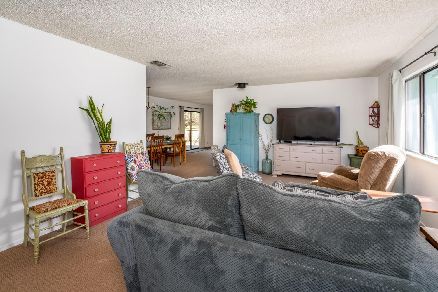 46011 Ming Circle Oakhurst, CA 93644 - Photo 7 of 37 a living room with furniture and a flat screen tv