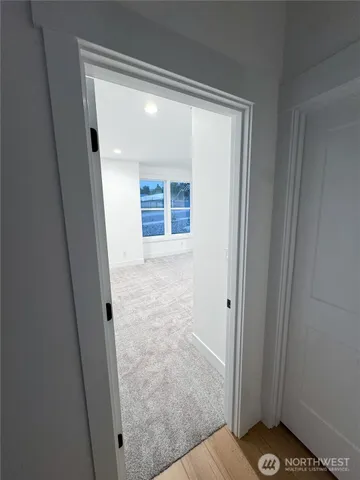 a view of empty room with wooden floor and fireplace