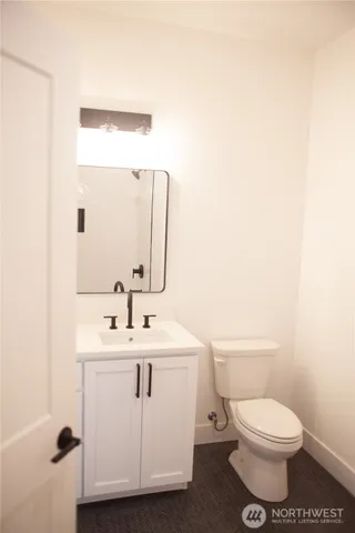 an empty room with wooden floor and entrance