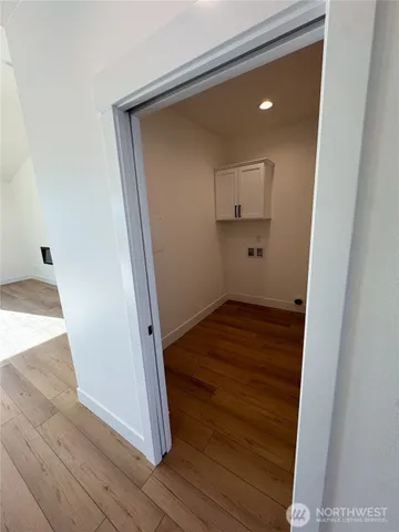 a view of kitchen with stainless steel appliances cabinets and wooden floor