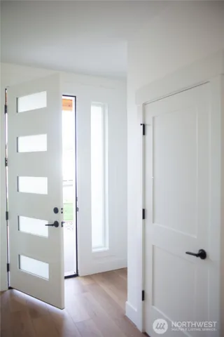 a view of a hallway with wooden floor